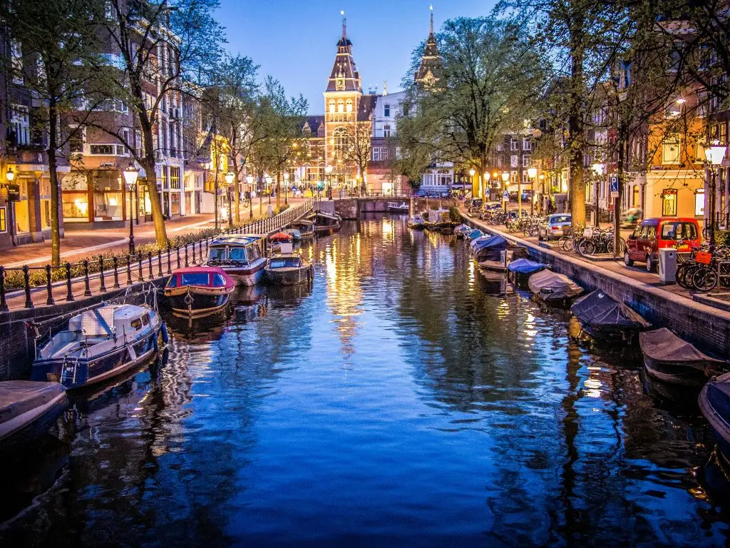 Canals and boats in Amsterdam. Photo via Flickr: Sergey Galyonkin.