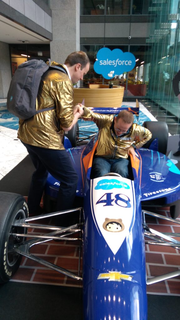 Paul trying to get out of an Indianapolis 500 car with Jurn helping
