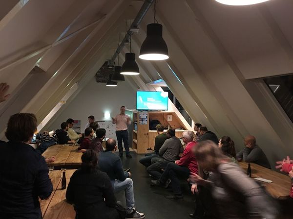 People sitting in a attic to a presenter