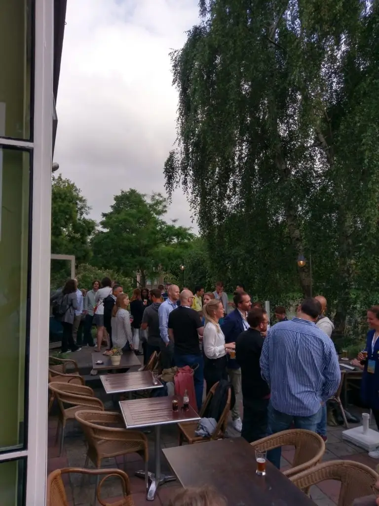 Lots of trailblazers mingling in greenery just outside a cafe