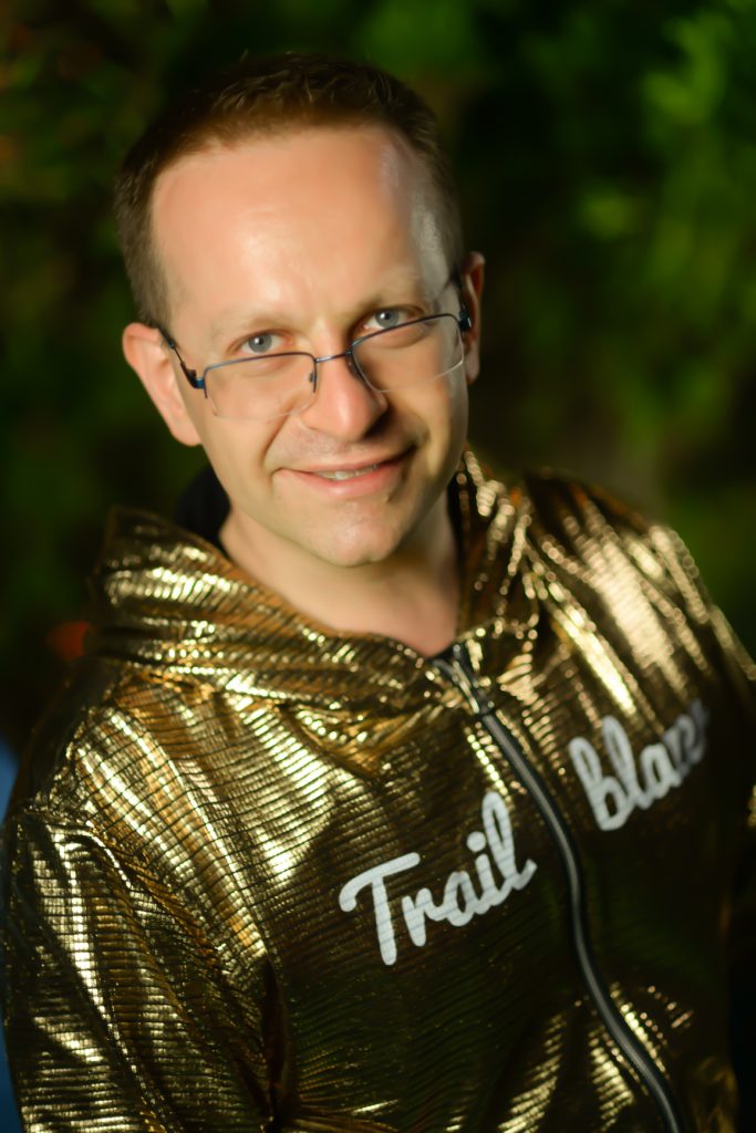 Picture of Paul Ginsberg in his Golden Hoodie staring intently at the camera but not zoomed in too much