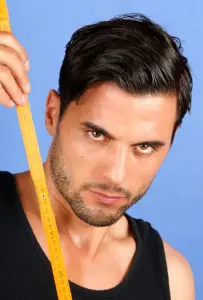 Hunky man holding a tape measure