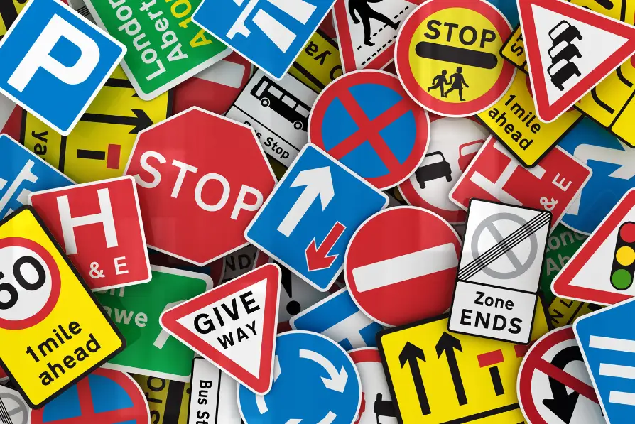Picture of various British road signs, many of which say "stop"