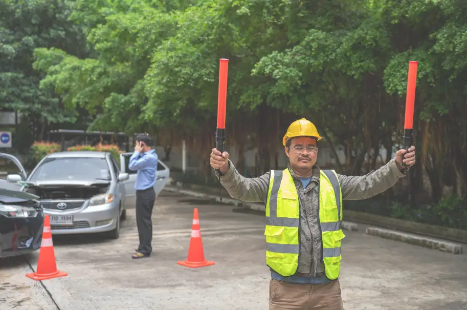 A man directing traffic in some country that's not the UK, US, NZ or Australia