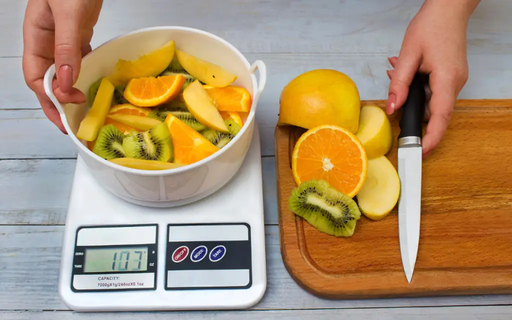 Picture of a bowl of mixed fruit being weighed