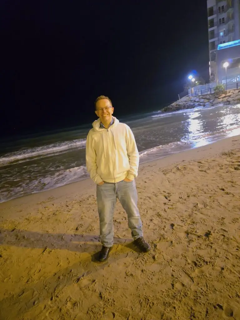 Me, standing on a beach when it is mainly dark.